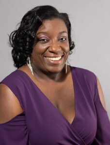 Michelle Poitier wearing a purple shirt