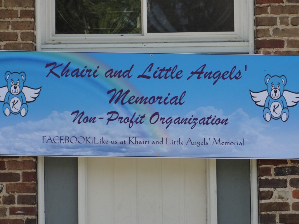 a sign in front of a brick building