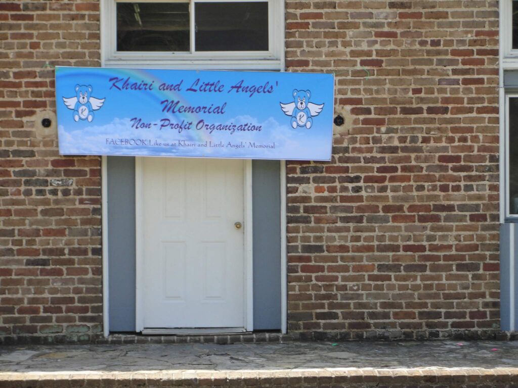a sign in front of a brick building