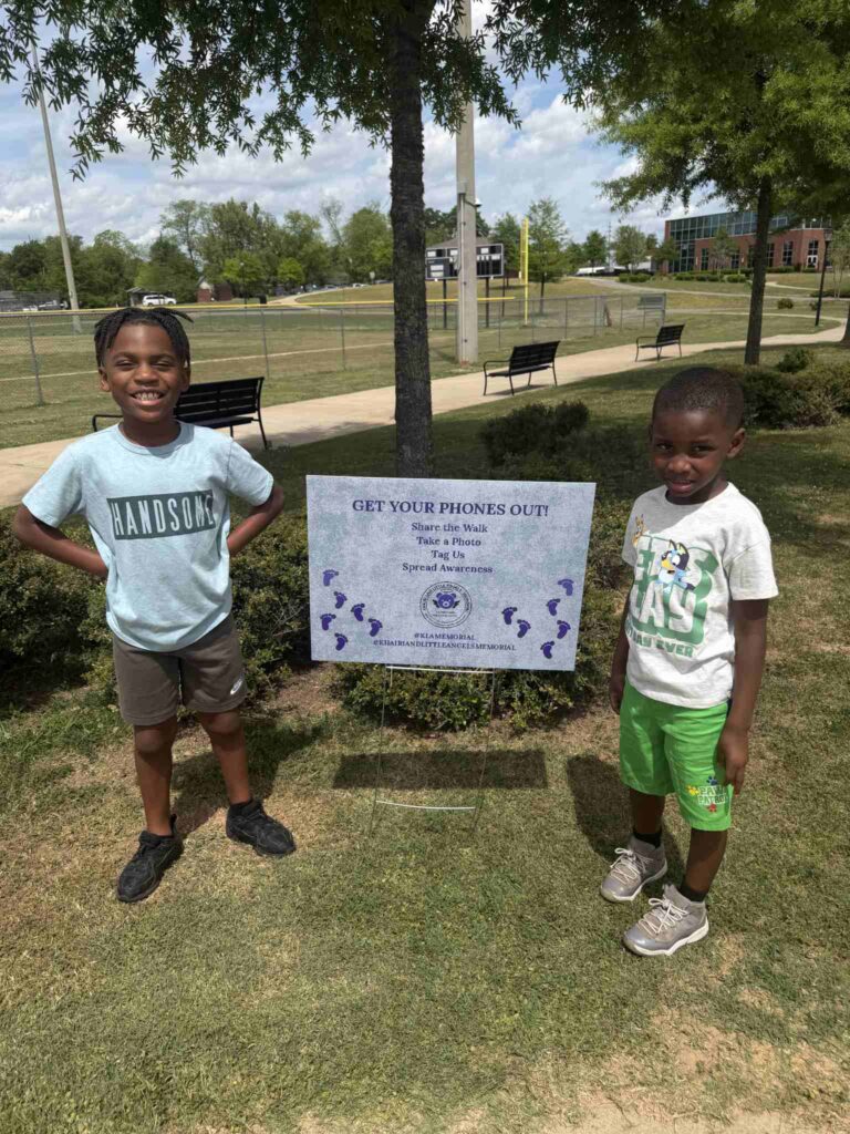 a man and a little boy that is standing in the grass