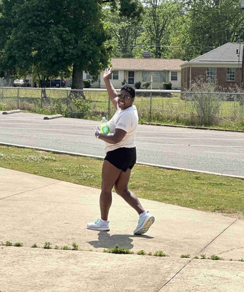 a person holding a frisbee in a yard