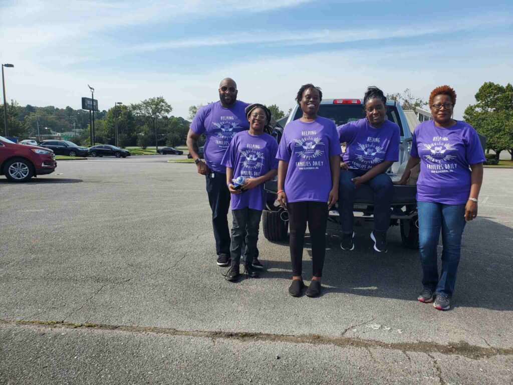 a group of people standing in a parking lot