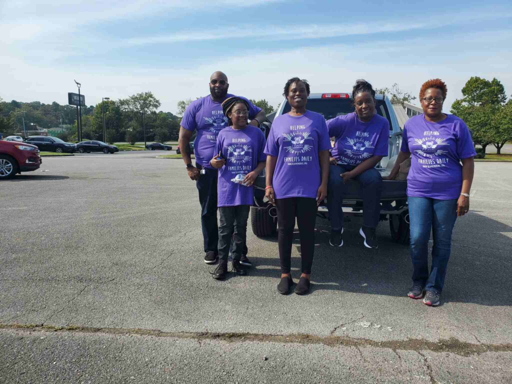 a group of people standing in a parking lot
