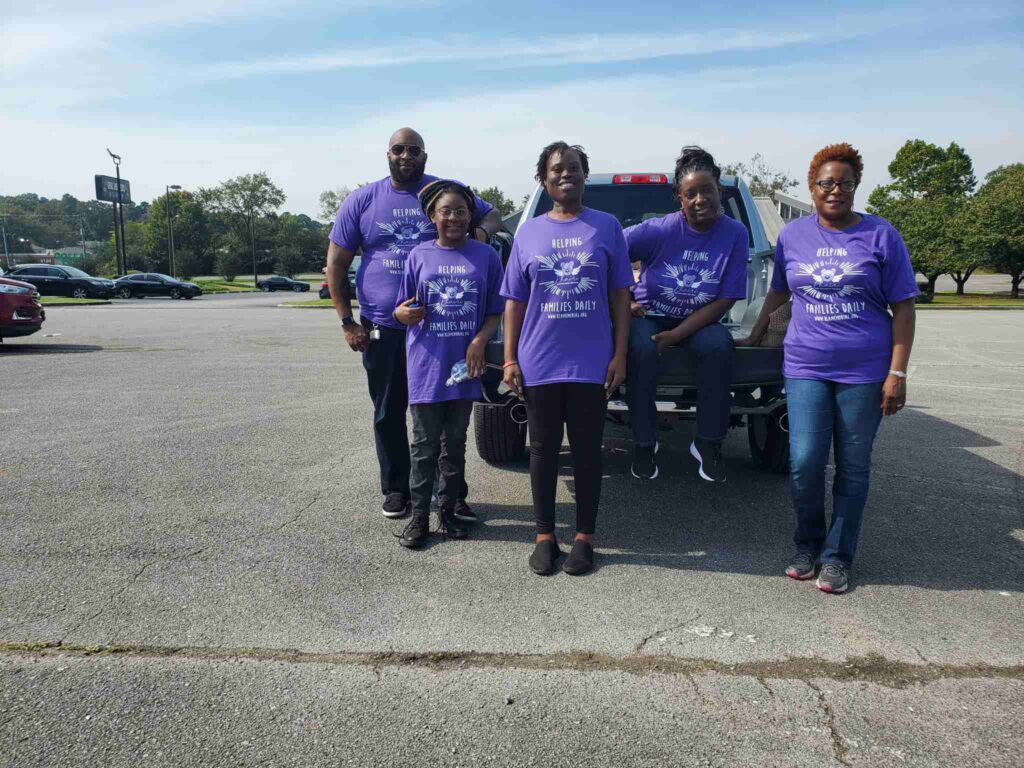 a group of people standing in a parking lot