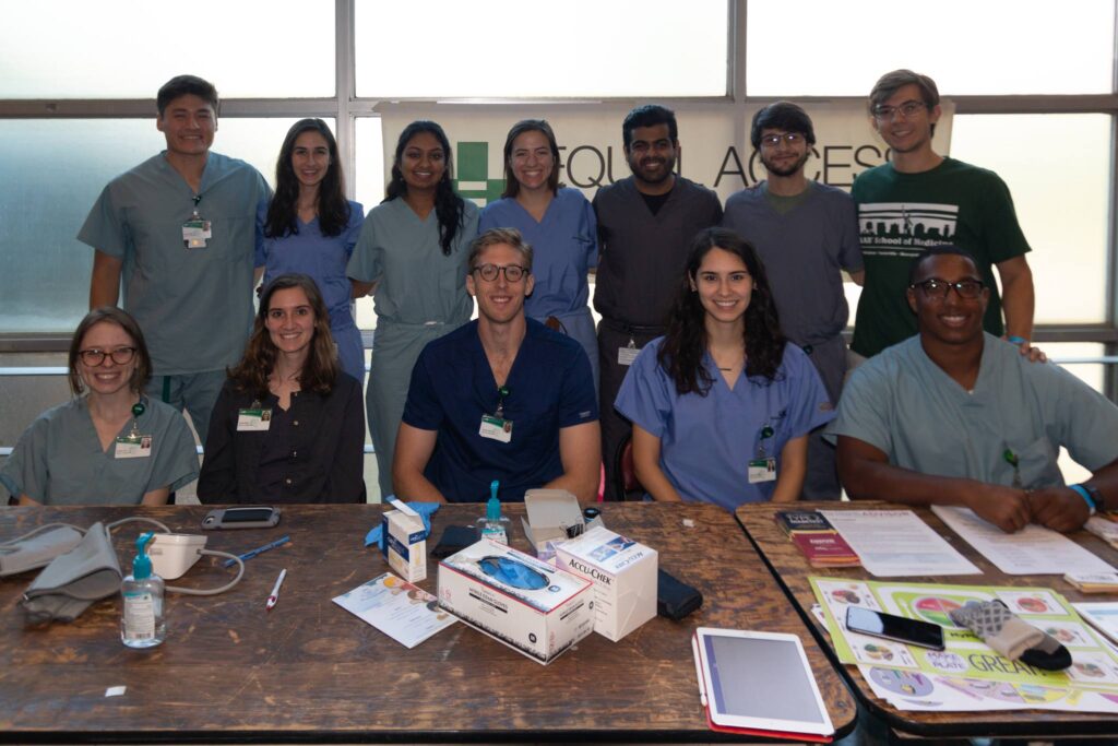 Erin Marisa Bates et al. posing for a photo on a table