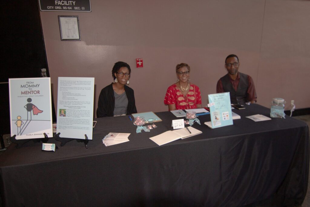 a group of people sitting at a table with a laptop
