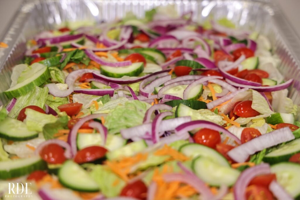 a tray of food with a slice of pizza