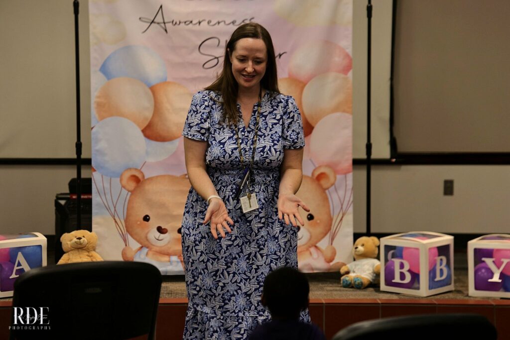 a woman standing in front of a cake
