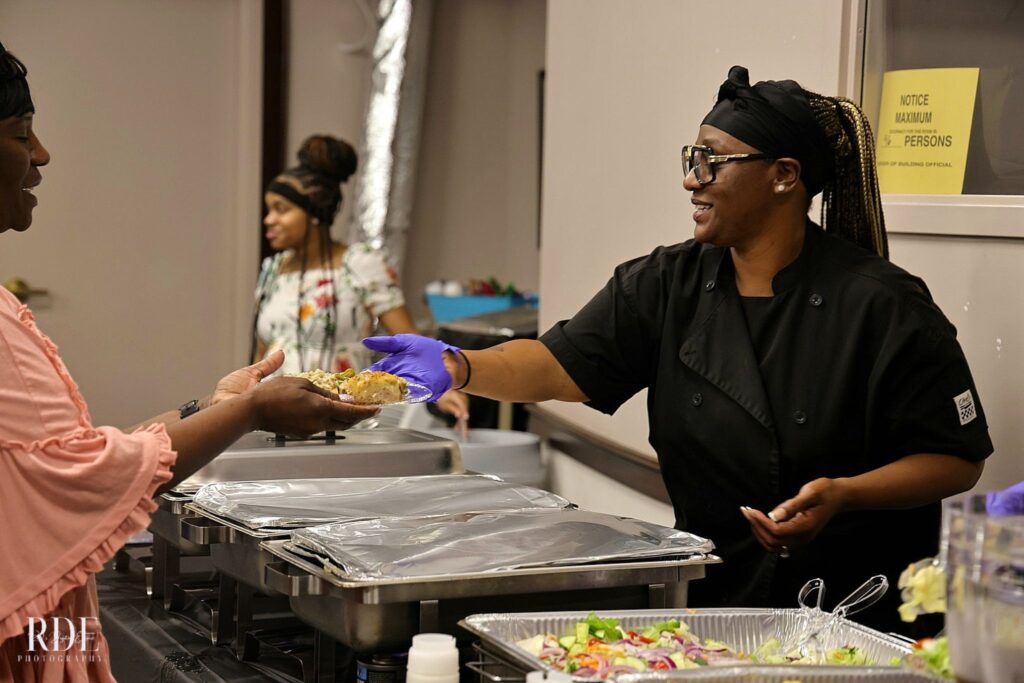 a man and woman preparing food in a kitchen